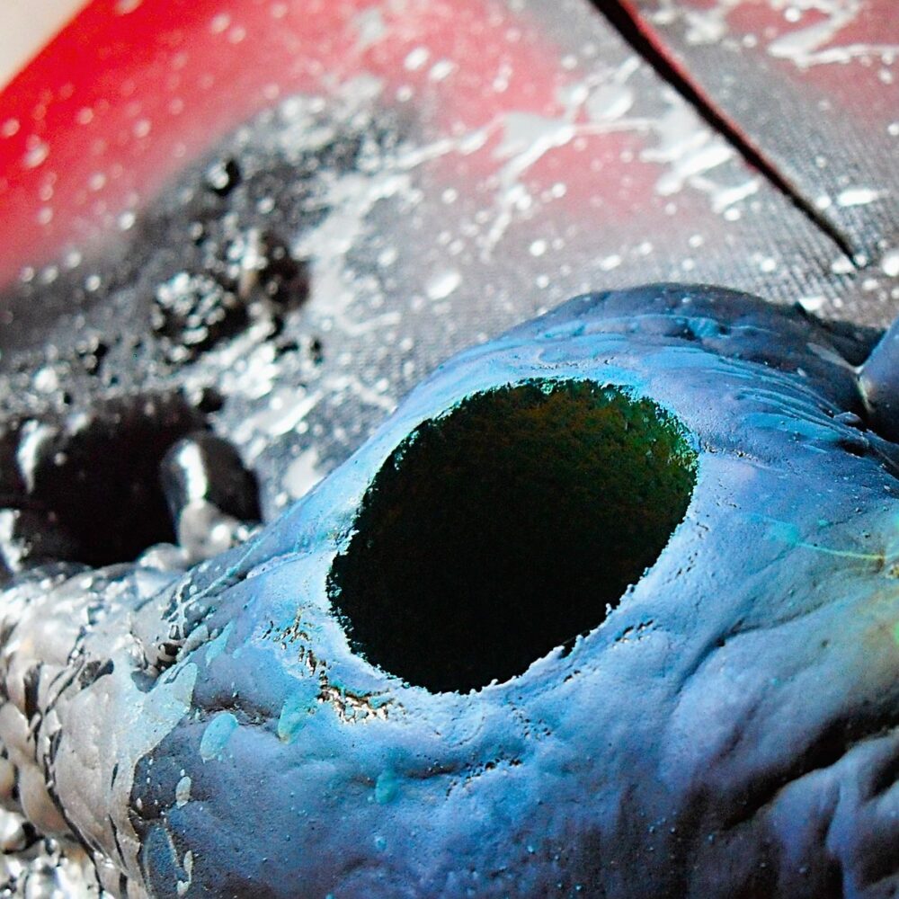 Detail of blue abstract material with circular hole on 3D philosophical canvas.