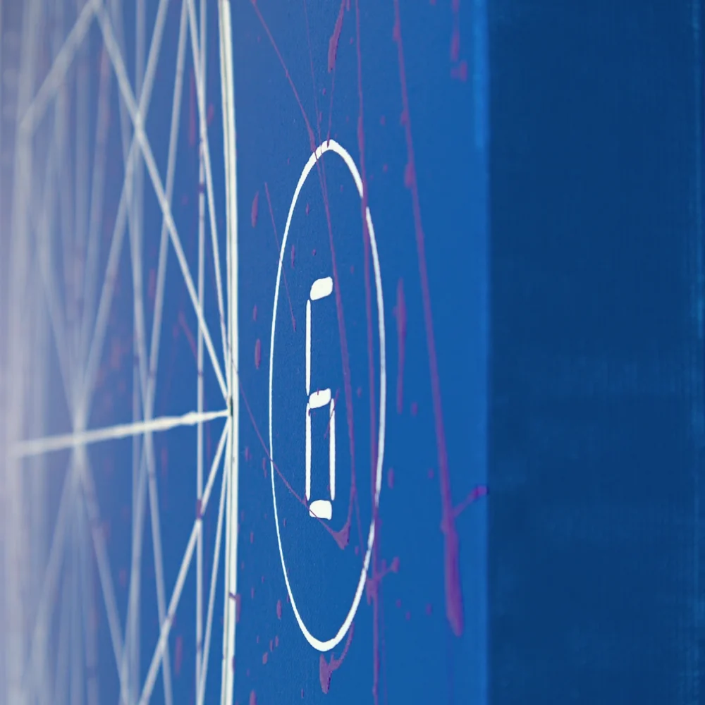 Close-up of dripping paint on circled digit painted between bigger circle containing geometric shapes and thick canvas edge created by Davide Canepa